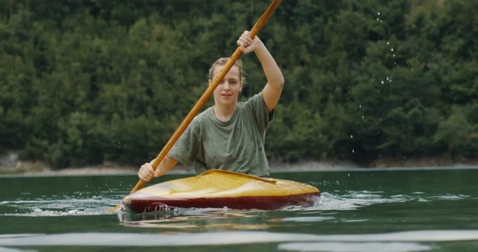 Woman Paddling In Kayak. Shot on RED Helium 8K