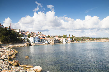 Obraz premium View over the bay with crystal clear water and typical houses in Koroni, Messinia, Greece 