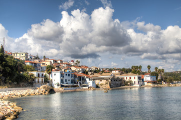 Naklejka na ściany i meble View over the bay with crystal clear water and typical houses in Koroni, Messinia, Greece 