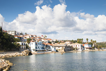 Fototapeta na wymiar View over the bay with crystal clear water and typical houses in Koroni, Messinia, Greece 