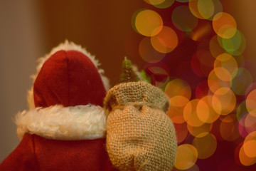 close up the back of Santa Claus statue and round light bokeh for Christmas background, filtered tones