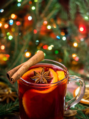 Christmas mulled wine with oranges and spices Christmas decorations with bokeh © Elenglush