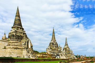 Fototapeta premium Ancient pagodas on red brick floor step are Ayutthaya, Thailand. This has blue sky be background of picture.