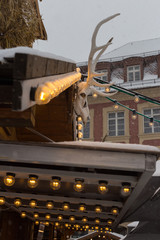 snowfall on christmas market with lights lamps and decoration in advent december © rudolfgeiger