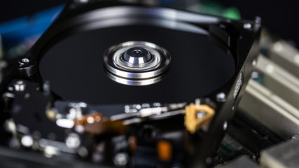 Disassembled hard drive from the computer, hdd with mirror effect Opened hard drive from the computer hdd with mirror effects Part of computer pc.
