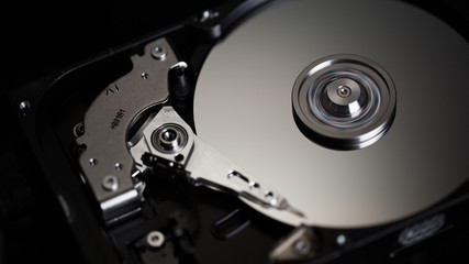 Disassembled hard drive from the computer, hdd with mirror effect Opened hard drive from the computer hdd with mirror effects Part of computer pc.