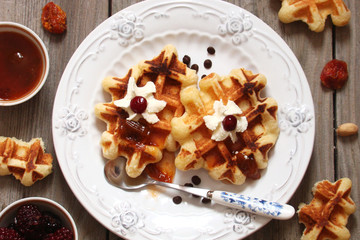 Waffles with whipped cream and berry jam