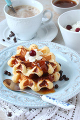 Waffles with whipped cream and berry jam
