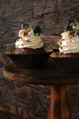 Cupcake with chocolate cream cheese, blueberry, chocolate chip and mint leaves