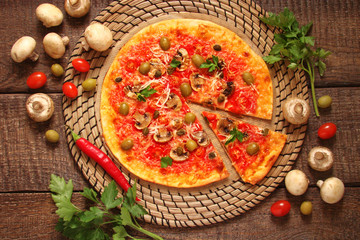 Pizza with tomatoes, mushrooms, black olives, Parmesan cheese, capers
