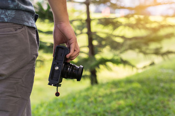 Young male hand holding camera, Photographer concept