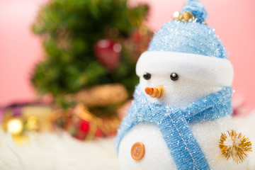 Happy snowman standing in gold winter christmas snow background. Merry christmas and happy new year greeting card with copy-space. Christmas celebration holiday background.