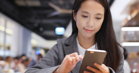 Woman read on cellphone in restaurant