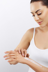 Skin Care Concept. Beautiful Woman With Hand Cream, Lotion On Her Hands. Closeup Portrait Of Happy Smiling Girl With Nude Makeup, Natural Manicure Applying Cosmetic Cream On Soft Skin.