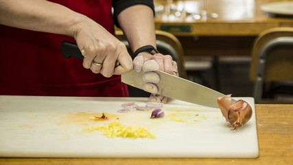 Close View of Shallots Being Sliced by Woman