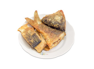 Fried pieces of carp on dish on a white background