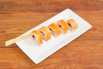 Sushi with salmon with chopsticks on rectangular dish