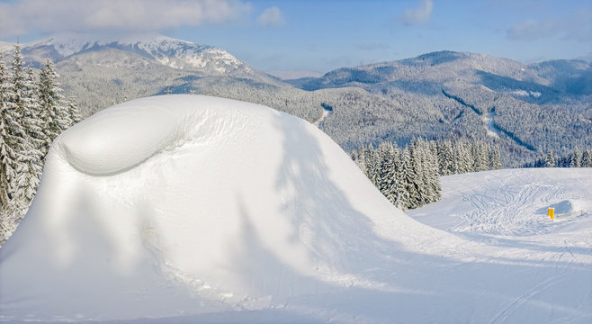 Snow-drift beside of ski piste on background of mountain