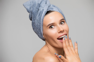 Woman with towel on head look amazedly