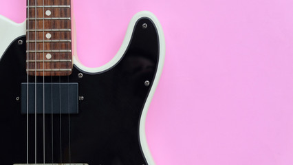 Fototapeta na wymiar Detail of Electric Guitar on a pink background.