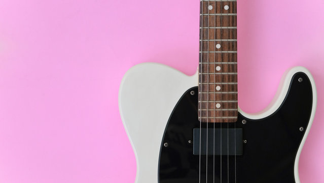 Detail of Electric Guitar on a pink background.
