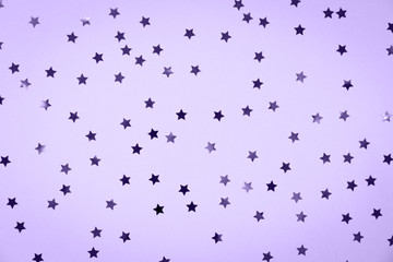 Star sprinkles festive holiday background. Celebration concept. Ultra violet tone, color of the year 2018