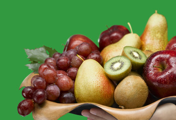 Mix fruits, red grapes, kiwi, pear, apple on green background