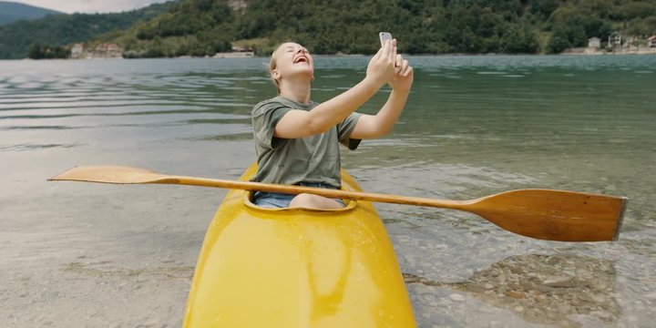 woman making selfie on lake in kaya. Shot on RED Helium 8K