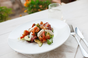Traditional italian seafood salad with shrimps and mozzarella