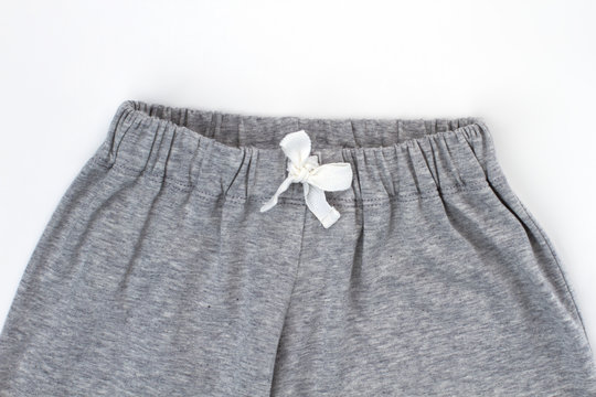 Close View On Gray Pants. Elastic Waistband And Adjusting Drawstring. Nightwear Bottom For Boys.