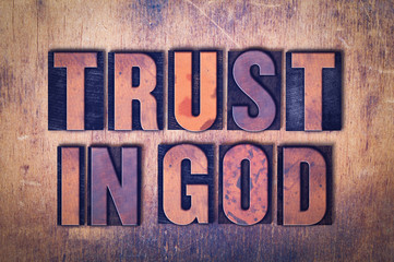 Trust in God Theme Letterpress Word on Wood Background