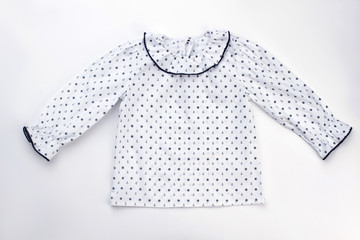Cute pajama top on white background. Ruffle cuffs and collar, sailor pattern fabric. Kids sleepwear and robes.