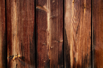  The wall of the vertically arranged old, burnt wooden boards.