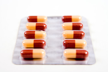 Pills, Red tablets over white background