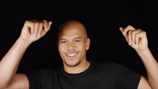 Attractive mixed race man enjoying himself by dancing in front of the camera