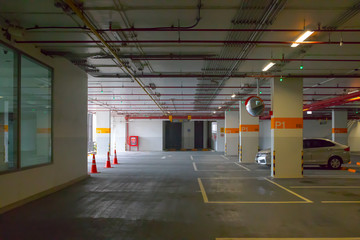 available car park in building showing electrical system on ceiling