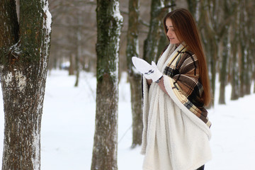 Young beautiful girl in winter snowy day