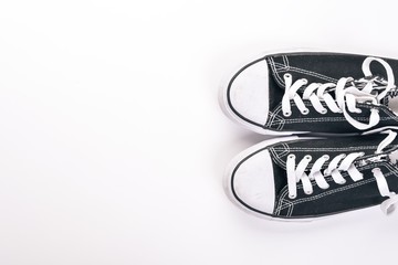 Sneakers, sports shoes on a wooden background. Top view. Free space for text.