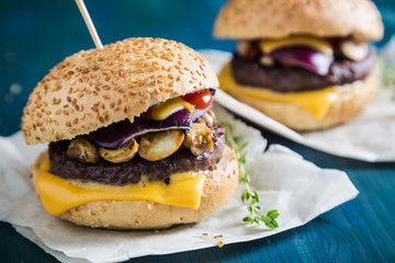 Hamburger with cheese and fried mushrooms