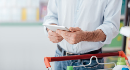 Man shopping and using a tablet