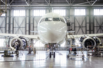 Passenger aircraft on maintenance of engine and fuselage repair in airport hangar. - obrazy, fototapety, plakaty