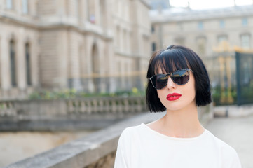 Woman with red lips on street of paris, france