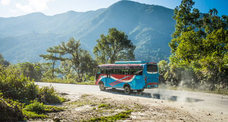 Colourful local bus on mountain road, Annapurna area, Nepal