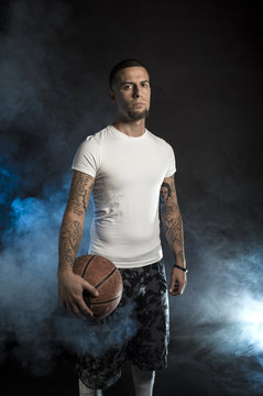 Studio portrait of sportsmen using balls