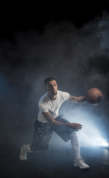 Studio portrait of sportsmen using balls