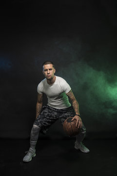 Studio portrait of sportsmen using balls