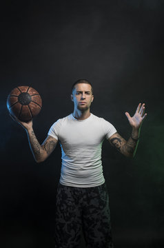 Studio portrait of sportsmen using balls
