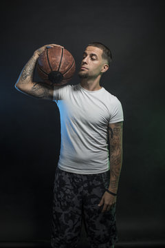 Studio portrait of sportsmen using balls