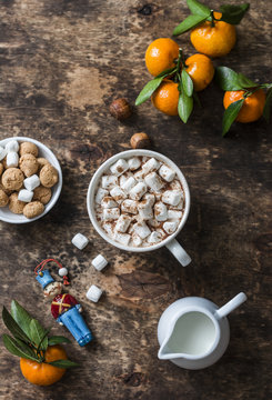 Cozy wooden background with hot chocolate, fresh tangerines, biscuits. Top view, flat lay