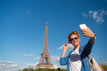 Happy woman make selfie at eiffel tower in paris, france